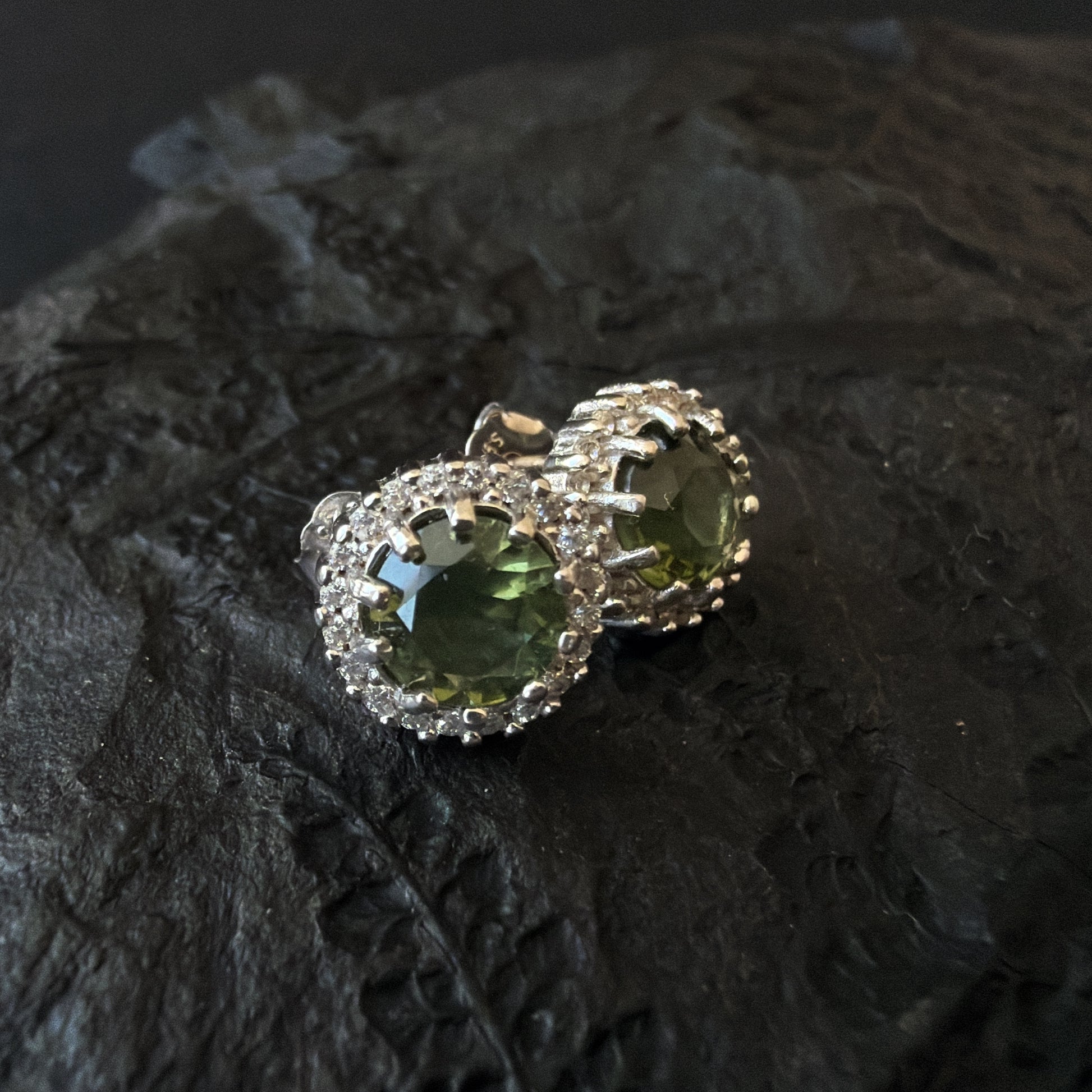 Jewelry with 6 mm Moldavite on a textured dark surface