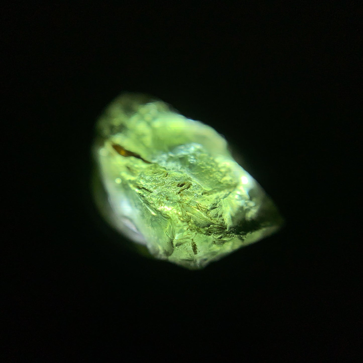 Macro shot of a raw moldavite under the light source