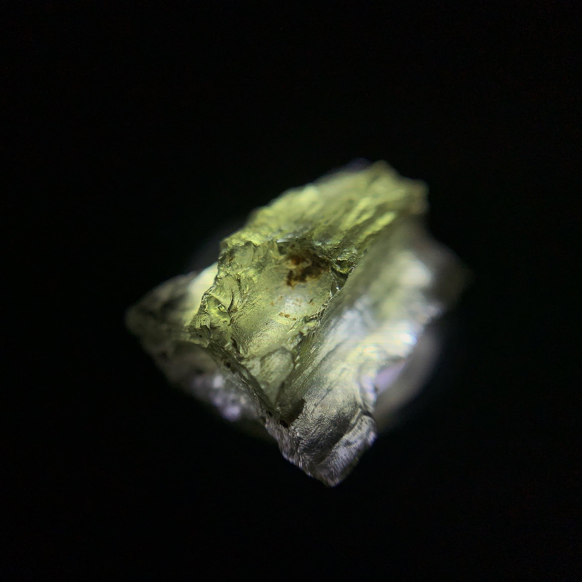 Macro shot of a raw moldavite under the light source