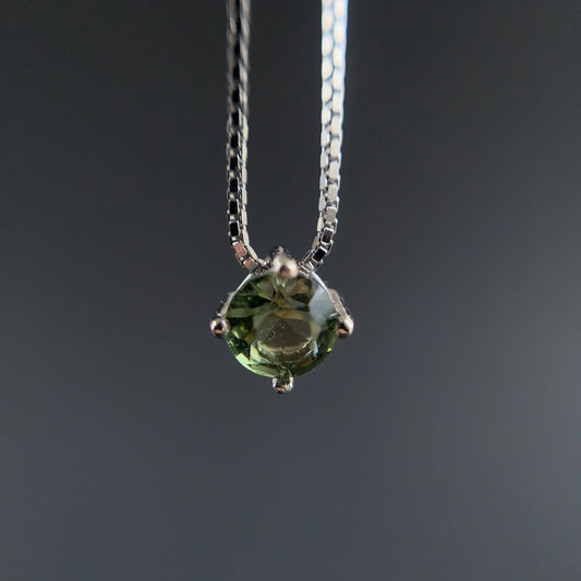 Green Moldavite 4mm necklace on a dark background